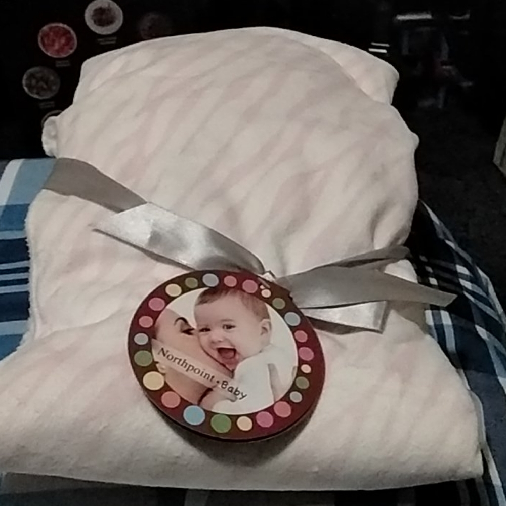 Pink and white baby blanket.
